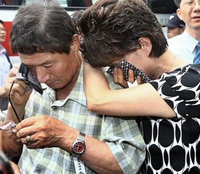 Relatives of South Koreans kidnapped in Afghanistan weep during a press conference after meeting with U.S. officials near the U.S. Embassy in Seoul, South Korea, Wednesday, Aug. 1, 2007. <br/>(Photo: Yonhap / Lee Sang-hak)