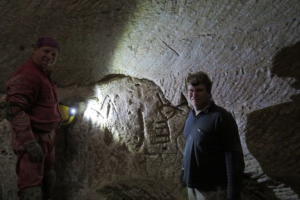 Hikers Ido Meroz and Mickey Barkal discovered rare, 2,100-year-old engravings of a cross and a menorah in an ancient water cistern in the Judean Shephelah. Note:  The photographer was the third person on the hike who discovered these etchings.<br />
 <br/>Sefi Givoni