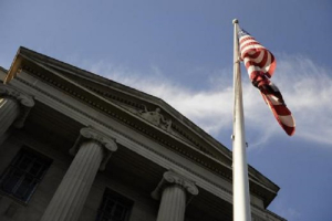 A US flag flies outside the U.S. Department of Justice headquarters building in Washington, July 14, 2009. <br />
<br />
 <br/>Reuters/Jonathan Ernst