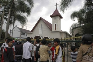 Indonesian youths gather outside the church that was attacked by Muslim hardliners in Temanggung, Central Java, Indonesia, Tuesday, Feb. 8, 2011. Hundreds of Islamic hard-liners stormed a courthouse and set two churches on fire Tuesday in central Indonesia to protest what they considered a lenient sentence for a Christian convicted of blaspheming Islam. <br/>AP/Slamet Riyadi