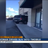 Upset lady drives her SUV into a T-Mobile store.