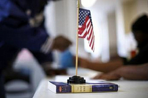 A miniature flag rests on a copy of the Bible at voter registration at West Philadelphia High School. <br/>Reuters