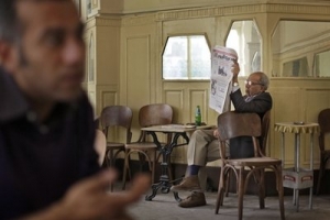 An Egyptian man reads a newspaper in a popular downtown cafe in Cairo, Egypt Tuesday, Feb. 15, 2011. Egypt's long banned Muslim Brotherhood said Tuesday it intends to form a political party once democracy is established, as the country's new military rulers launched a panel of experts to amend the country's constitution enough to allow democratic elections later this year. <br/>AP/Ben Curtis