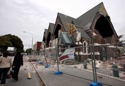 People walk past a church in Christchurch, New Zealand, which was destroyed after an earthquake struck Tuesday, Feb. 22, 2011. The 6.3-magnitude quake collapsed buildings and is sending rescuers scrambling to help trapped people amid reports of multiple deaths. <br/>AP/NZPA, Pam Johnson