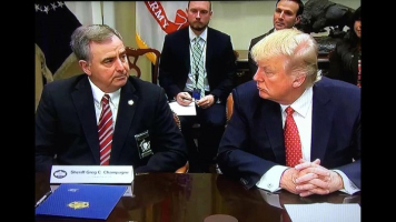 Pres. Donald Trump in a discussion with National Sheriffs' Association president Greg Champagne at the White House <br/>Facebook/Greg Champagne