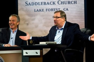 Former British Prime Minister Tony Blair, left, laughs with Pastor Rick Warren during the ''Civil Forum on Peace In a Globalized Economy'' at Saddleback Church in Lake Forest, Calif. on Sunday, March 6, 2011. Blair served as Prime Minister of the United Kingdom from May 1997 to June 2007 and is the founder of the Tony Blair Faith Foundation. The event was hosted by Pastor Rick Warren at Saddleback Church. <br/>AP/Orange County Register, Paul Bersebach