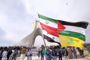 A man carries a giant flag made of flags of Iran, Palestine, Syria and Hezbollah, during a ceremony marking the 37th anniversary of the Islamic Revolution, in Tehran Feb. 11, 2016. Iran on March 26, 2017, announced sanctions against 15 U.S. companies. <br/>Reuters 