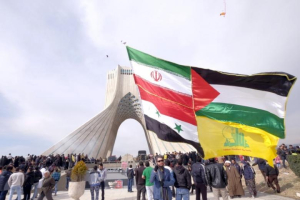 A man carries a giant flag made of flags of Iran, Palestine, Syria and Hezbollah, during a ceremony marking the 37th anniversary of the Islamic Revolution, in Tehran Feb. 11, 2016. Iran on March 26, 2017, announced sanctions against 15 U.S. companies. <br/>Reuters 