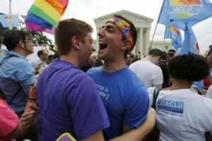 Gay rights supporters celebrate after the U.S. Supreme Court ruled that the U.S. Constitution provides same-sex couples the right to marry, outside the Supreme Court building in Washington, June 26, 2015. <br />
 <br/>Reuters/Jim Bourg