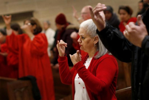 Congregants respond in sign language during a mass at St. Elizabeth of Hungary in Manhattan during a Christmas service for its deaf congregation.<br />
 <br/>Reuters 