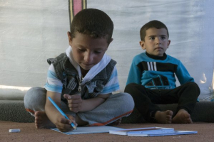 In this Wednesday, April 5, 2017 photo, 6-year-old, Mustafa, left, draws on a piece of paper next to another child in a tent, at the Khazer refugee camp in east Mosul, Iraq, Wednesday, April 5, 2017. <br/>AP Photo/Yesica Fisch