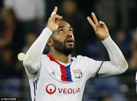 Lyon's Alexandre Lacazette celebrates scoring by holding up his arms and  pointing to the sky  <br/>Reuters