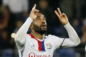 Lyon's Alexandre Lacazette celebrates scoring by holding up his arms and  pointing to the sky  <br/>Reuters