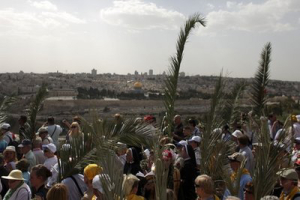 Christian pilgrims participate in the traditional Palm Sunday procession on the Mount of Olives, overlooking Jerusalem's Old City, Sunday, April 17, 2011. Palm Sunday commemorates Jesus Christ's triumphant entry into Jerusalem, and is the start of the Christian Holy Week. <br/>Christian pilgrims participate in the traditional Palm Sunday procession on the Mount of Olives, ove