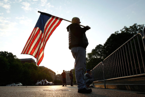 Dan Parker of Shamokin, Pennsylvania, holds a U.S. flag outside the White House in Washington May 2, 2011. Parker came here after learning the killing of Osama bin Laden. The Al Qaeda leader was killed in a U.S.-led operation involving helicopters and ground forces in Pakistan on Sunday, ending a nearly 10-year worldwide hunt for the mastermind of the September 11 attacks. <br/>Reuters / Kevin Lamarque