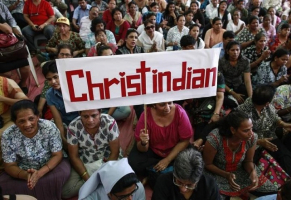 A protester holds a placard during a rally by hundreds of Christians against recent attacks on churches nationwide, in Mumbai February 9, 2015.  <br/>Reuters/Danish Siddiqui