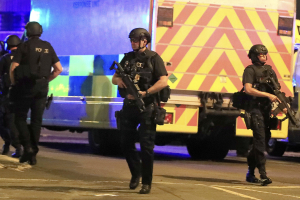 Armed police respond after reports of an explosion at Manchester Arena during an Ariana Grande concert <br/>The Guardian