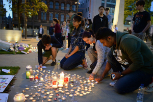 People leave tributes and light candle by City Hall in Manchester for victims of the Manchester terrorist attack. <br/>AP Photo