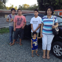 (Photo: Facebook) Pastor Roger's family posing beside the car, Toyota Wigo <br/>