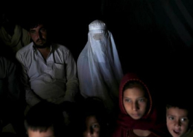 An Afghan family, returning from Pakistan, watch a short video clip about mines during a mines and explosives awareness program at a United Nations High Commissioner for Refugees (UNHCR) registration centre in Kabul.  <br/>Reuters 