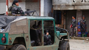 Police patrol the streets of Marawi city as government troops battle with Muslim militants who continue to hold their ground in some areas of the city. <br/>AP Photo/Bullit Marquez