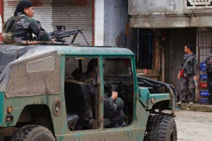 Police patrol the streets of Marawi city as government troops battle with Muslim militants who continue to hold their ground in some areas of the city. <br/>AP Photo/Bullit Marquez