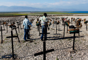 Men who lost relatives in the country's January 2010 earthquake visit the mass grave site in Titanyen on the outskirts of Port-au-Prince March 21, 2011. <br/>Reuters / Shannon Stapleton