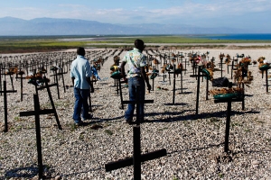 Men who lost relatives in the country's January 2010 earthquake visit the mass grave site in Titanyen on the outskirts of Port-au-Prince March 21, 2011. <br/>Reuters / Shannon Stapleton
