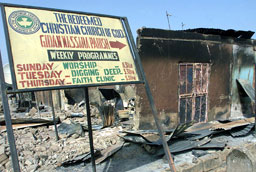 This file photo shows a sign pointing towards a church burned down by riots in northern Nigeria. <br/>Reuters/Juda Ngwenya