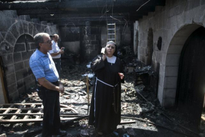 A nun stands at the scene of a fire in the Church of Loaves and Fishes on the shores of the Sea of Galilee in northern Israel, June 18, 2015.  <br/>Reuters