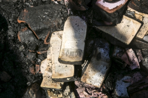 Partially burnt leaflets are seen on the floor of the Church of Loaves and Fishes on the shores of the Sea of Galilee in northern Israel, June 18, 2015. <br/>Reuters