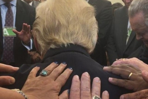 Evangelical pastor Rodney Howard-Browne posted this image of himself and wife Adonica leading prayers over President Trump on Monday as people laid their hands on him <br/>Facebook