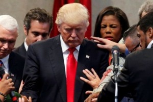 Members of the clergy lay hands and pray over Republican presidential nominee Donald Trump at the New Spirit Revival Center. <br/>Reuters