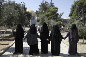 Palestinian female activists form a chain to prevent a group of religious Jews from coming close to the Dome of the Rock at the Al-Aqsa compound in Jerusalem in July 2015.  <br/>Mahmoud Illean AP