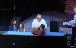 Pastor Robert Hogan of the Spring First Church in Houston, Texas baptizes Jacob McKelvy, founder of the Greater Church of Lucifer. <br/>Screenshot/YouTube/Jacob McKelvy