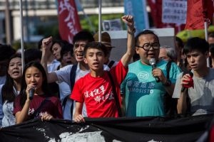 Derek Lam, second from right, marches in Hong Kong on Sunday to protest the jailing of Joshua Wong, Nathan Law and Alex Chow. <br/>Isaac Lawrence/Agence France-Presse — Getty Images