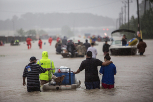 A mix of first responders and volunteer rescuers help evacuate people stranded by floodwaters on the outskirts of Houston off Beltway 8 on Monday.  <br/>Tamir Kalifa for The New York Times