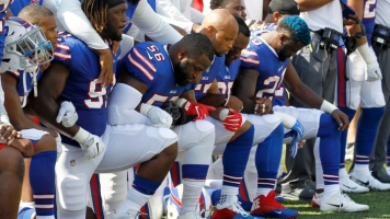 Buffalo Bills players kneel during the national anthem before a game versus the Denver Broncos. <br/>AP Photo/Jeffrey T. Barnes