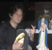 The 19-year-old poses for a picture after breaking the heads off a statue of Mary holding Jesus. <br/>Facebook