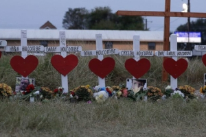 Crosses for members of the Holcombe family are part of a makeshift memorial for the victims of the church shooting at Sutherland Springs Baptist Church placed along the highway, Friday, Nov. 10, 2017, in Sutherland Springs, Texas.  <br/>(AP Photo/Eric Gay)