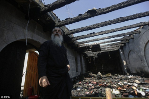 A cleric inspects the damage caused to the complex of the Church of Loaves and Fishes on June 18, 2015. <br/>Reuters
