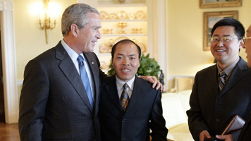 Li Baiguang, pictured with former President George W. Bush, died under “mysterious” circumstances, supporters say. <br/>CNN