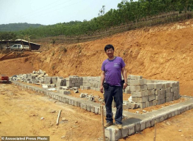 Rev. John Sanqiang Cao breaks a ground on a new school in Wa State, Myanmar. <br/>Ben Cao via AP 