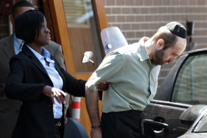 Murder suspect Levi Aron is escorted out of a New York Police Department precinct in Brooklyn, New York, July 14, 2011. Aron is under arrest in connection to the dismembered remains of Leiby Kletzky, 8, who had gotten lost walking home from camp, found in a freezer and a trash container on Wednesday. <br/>Reuters/Brendan McDermid