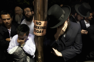 Men weep while listening to the funeral of Leibby Kletzky outside a synagogue in the Brooklyn borough of New York July 13, 2011. A Brooklyn man was under arrest on Wednesday after the dismembered remains of Kletzky, who had gotten lost two days earlier walking home from camp, were found in the man's freezer and a trash container, police said. Kletzky, 8, was supposed to meet his family on Monday on his walk home from day camp in Brooklyn's Borough Park neighborhood but never arrived, police said. <br/>Reuters/Lucas Jackson