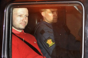 Anders Behring Breivik, the man accused of a killing spree and bomb attack in Norway, sits in the rear of a vehicle as he is transported in a police convoy as he is leaving the courthouse in Oslo, July 25, 2011. <br/>Reuters / Jon-Are Berg-Jacobsen