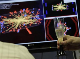 A scientist holds a glass of champagne after the first successful collisions at full power at the Compact Muon Solenoid (CMS) experience control room at the Large European Organisation for Nuclear Research (CERN) in Meyrin, near Geneva, March 30, 2010. <br/>Reuters/Denis Balibouse
