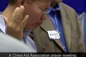 In this still-shot from a video, Bob Fu, president of the China Aid Orgnization, which often reports about persecution of Christians in China, prays with U.S. Christians for the safety of the persecuted church in China, a year before the Summer Olympsic in Beijing. <br/>(Video, Courtesy of China Aid Association)