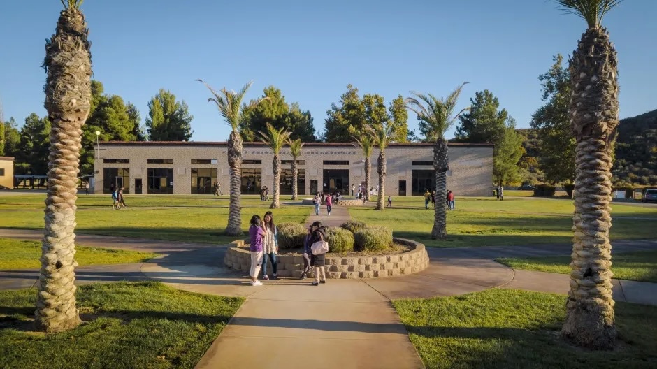 Olivet University students walking and chatting on campus in Anza, CA. 