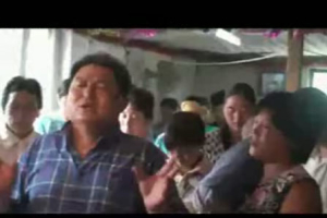 In this still-shot of a video released by the Chinese Christianity Family Federation, an unidentified house church pastor in Beijing leads his congregation in prayer for the 2008 Summer Olympics in Beijing. U.S. and mainland China Christians prayed together for the persecuted church in China, a year before the Olympics. <br/>(Video, Courtesy of China Aid Association)